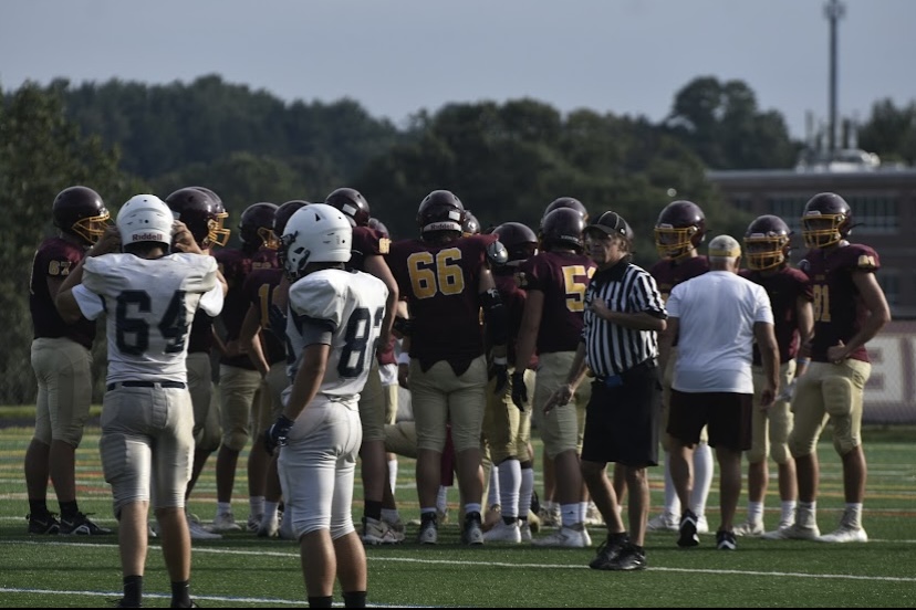 Varsity+football+gathers+in+a+huddle+mid-game+against+Manchester+Valley+on+Aug+19.