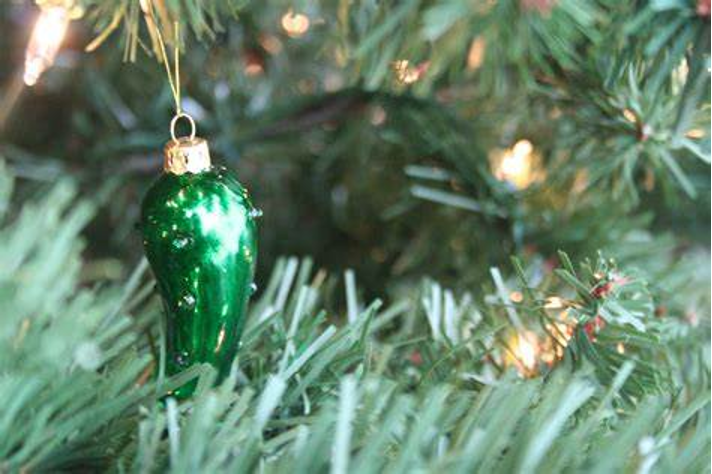 The tradition of the Christmas pickle involves hiding pickle shaped ornaments in the branches of the Christmas tree.
