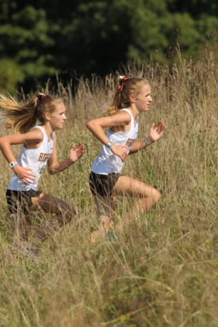 Twins Delaney (‘24) and Alison (‘24) Kline run together in the 2021 Eagle Invitational. The twins took first and second. Photo provided by John Romer.
